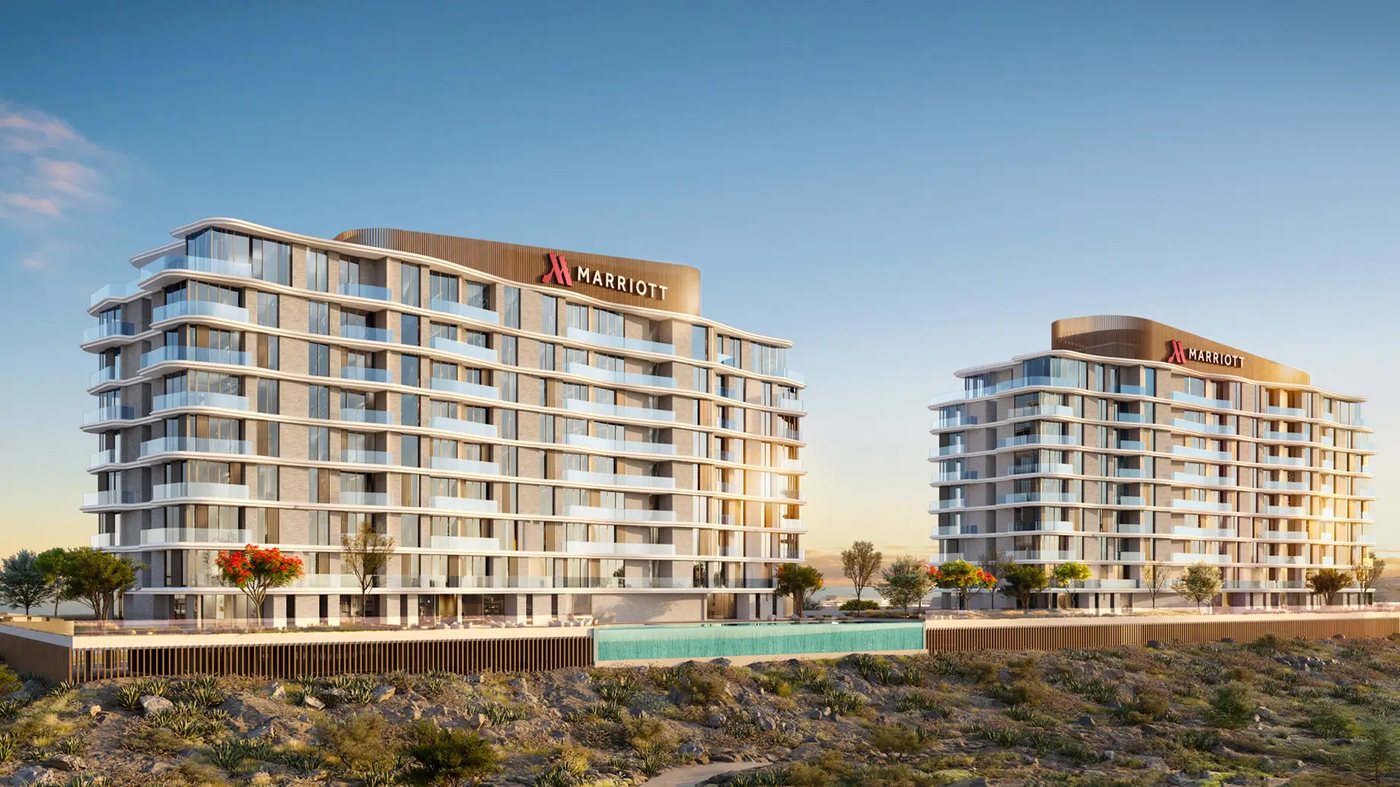 Two Marriott Residences AIDA towers beside the infinity pool at sunset